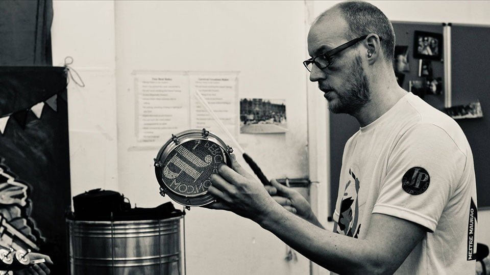 JP Courtney playing a tambourine